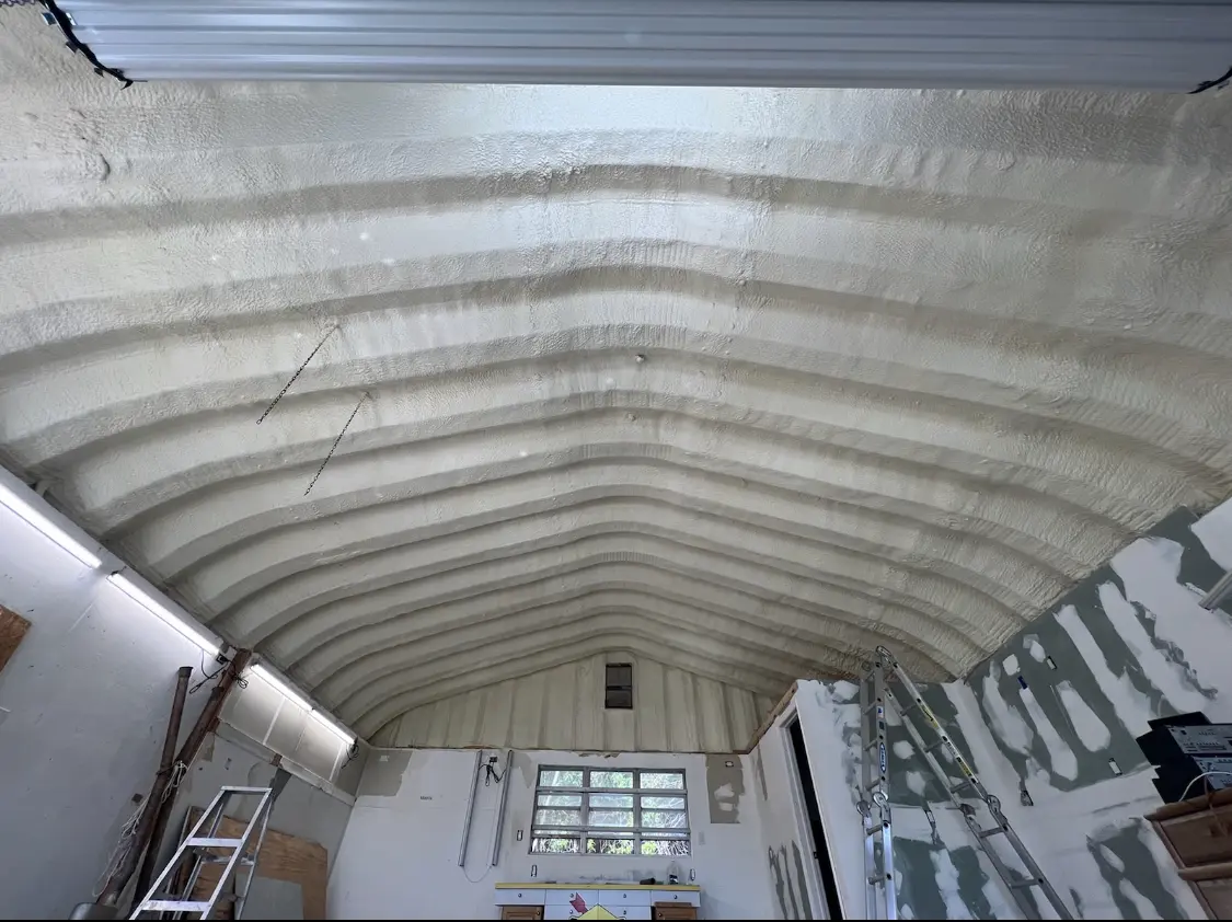 Spray polyurethane foam applied to the underside of a metal roof deck in Fletcher